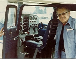 Claude standing by the cockpit of his single engine Cessna.