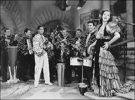 Claude appears playing his accordion in this 1939 motion picture musical An Old Spanish Custom, later renamed In Rhumba Land, featuring the Darryl Harpa Orchestra and celebrated singer, Wini Shaw.  (Released through Universal Studios. Still searching for a film copy, please help.)